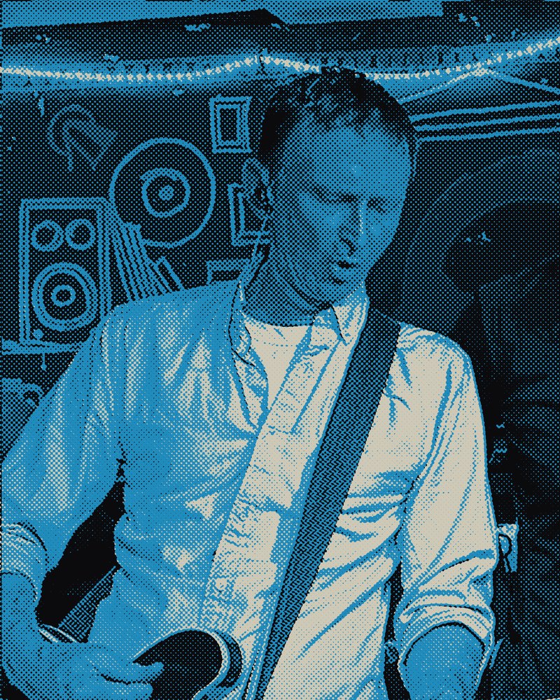 Gavin playing guitar and singing